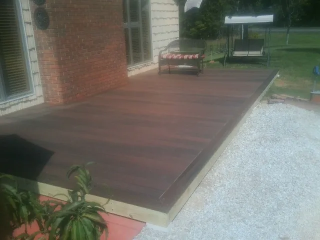 Freshly stained wood deck built against a brick home in Sugarcreek
